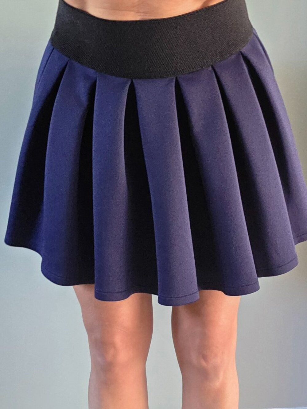 Dark blue pleaded mini skirt with large black elastic waistband size extra small